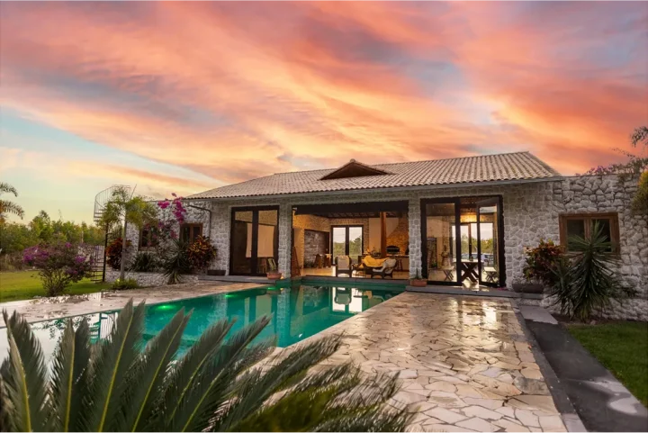 Stylish stone villa with private pool at sunset in Mallorca, representing luxury accommodation options curated by Balearic Elements, a local Destination Management Company for the Balearic Islands. The DMC offers carefully selected properties to suit every style and budget, from luxury resorts and finca hotels to boutique and global hotel chains.